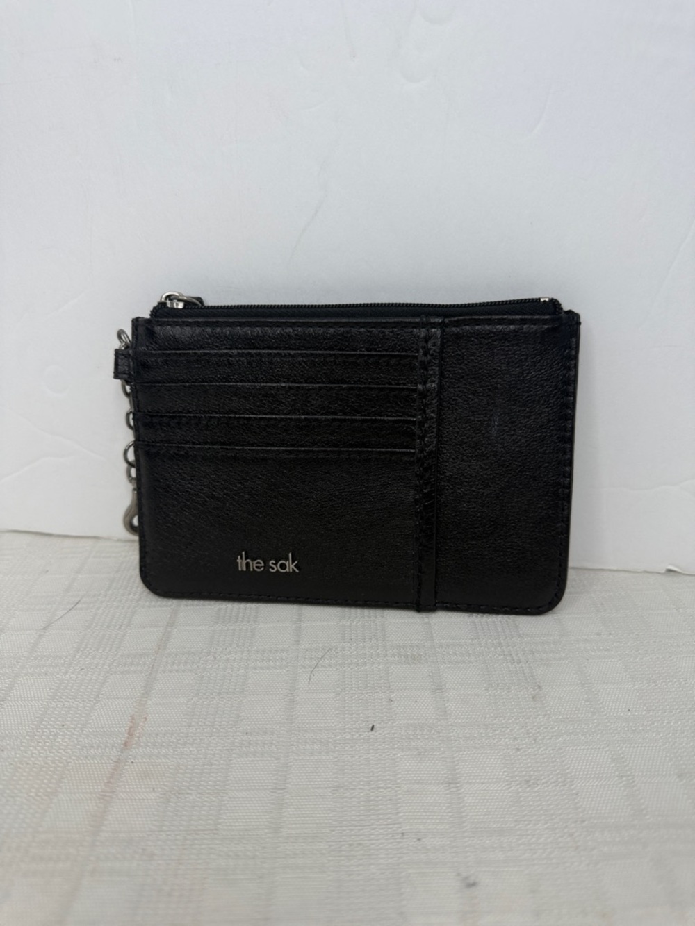 The Sak Black the Iris Leather Zip Card wallet.